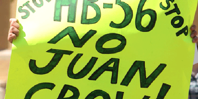 Ashley Hendricks, a University of Alabama student from Huntsville, holds a sign and chants while protesting HB-56 on Wednesday, Sept. 28, 2011.