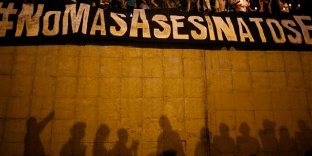 Demonstrators display on June 8, 2017 a banner that reads "No More Killings" near the spot where protester Neomar Lander died.