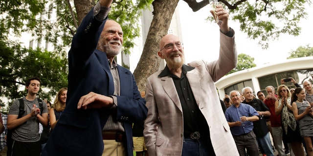 Scientists Barry Barish, left, and Kip Thorne, both of the California Institute of Technology, share a toast to celebrate winning the Nobel Prize in Physics Tuesday, Oct. 3, 2017, in Pasadena, Calif. Barish and Thorne won the Nobel Physics Prize on Tuesday for detecting faint ripples flying through the universe, the gravitational waves predicted a century ago by Albert Einstein that provide a new understanding of the universe. (AP Photo/Jae C. Hong)