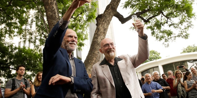 Scientists Barry Barish, left, and Kip Thorne, both of the California Institute of Technology, share a toast to celebrate winning the Nobel Prize in Physics Tuesday, Oct. 3, 2017, in Pasadena, Calif. Barish and Thorne won the Nobel Physics Prize on Tuesday for detecting faint ripples flying through the universe, the gravitational waves predicted a century ago by Albert Einstein that provide a new understanding of the universe. (AP Photo/Jae C. Hong)