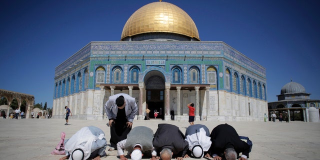 Oct. 5, 2014: Palestinians from Gaza pray in front of the Dome of the Rock during their visit at the compound known to Muslims as Noble Sanctuary and to Jews as Temple Mount in Jerusalem's Old City.