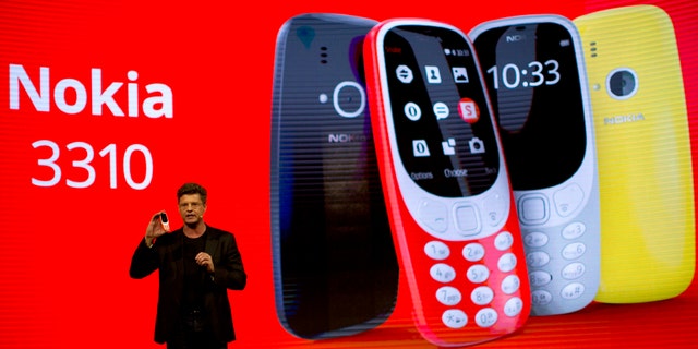 Arto Nummela, Chief Executive Officer at HMD Global, shows the new re-launched Nokia 3310 phone, ahead of Monday's opening of the Mobile World Congress wireless show in Barcelona, Spain, Sunday, Feb. 26, 2017. (AP Photo/Emilio Morenatti)