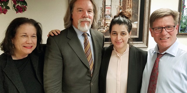 March 30, 2018: Noor Salman, second from right, and her attorneys pose for a photo after Salman was acquitted of lying to the FBI and helping her husband attack the Pulse nightclub in Orlando, Fla. The attorneys, Linda Moreno, Fritz Scheller, Charles Swift pose with Salman from left.