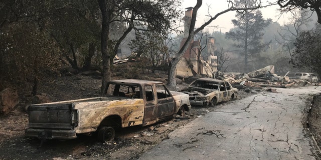 Charred remains of vehicles after wildfires in Northern California.