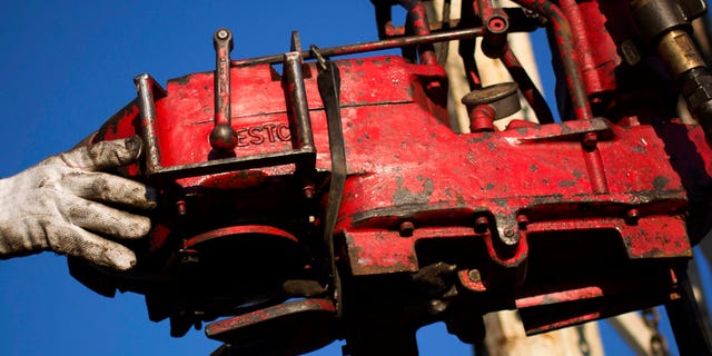 M arch 12: 2013: A man works on the rig of an oil drilling pump site in McKenzie County outside of Williston, North Dakota.