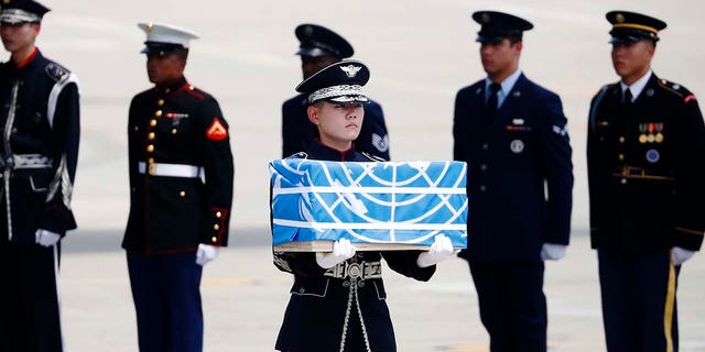 A soldier carries a casket containing what was believed to be the remains of a U.S. soldier who was killed in the Korean War, during a ceremony at Osan Air Base in Pyeongtaek, South Korea, July 27, 2018.