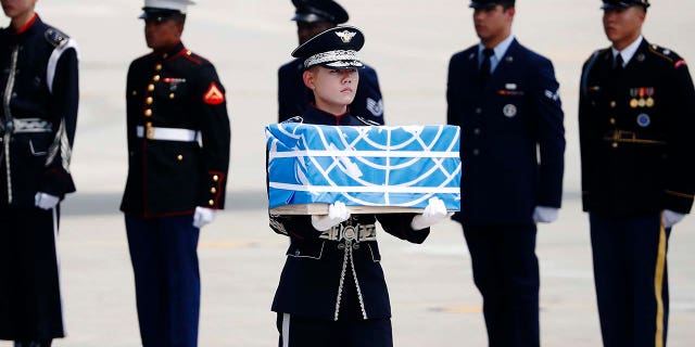 A soldier carries a casket containing what was believed to be the remains of a U.S. soldier who was killed in the Korean War, during a ceremony at Osan Air Base in Pyeongtaek, South Korea, July 27, 2018.