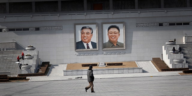Feb. 14, 2016: A man walks past portraits of the late North Korean leaders Kim Il Sung and Kim Jong Il at Kim Il Sung Square in Pyongyang, North Korea (AP/Wong Maye-E)
