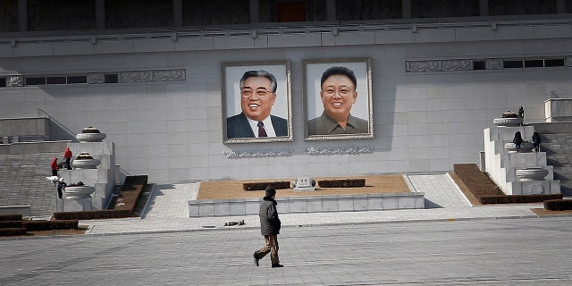 Feb. 14, 2016: A man walks past portraits of the late North Korean leaders Kim Il Sung and Kim Jong Il at Kim Il Sung Square in Pyongyang, North Korea (AP/Wong Maye-E)