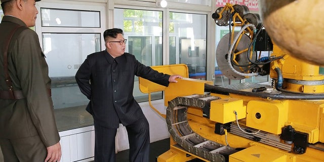 Kim Jong Un, center, visits the Chemical Material Institute of Academy of Defense Science at an undisclosed location in North Korea.