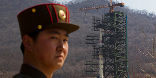 April 8: A North Korean soldier stands in front of the country's Unha-3 rocket, slated for liftoff between April 12-16, at a launching site in Tongchang-ri, North Korea.
