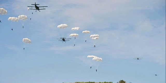 North Korea paratroopers jump out of two Antonov An-2 transport aircrafts.