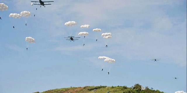 North Korea paratroopers jump out of two Antonov An-2 transport aircrafts.