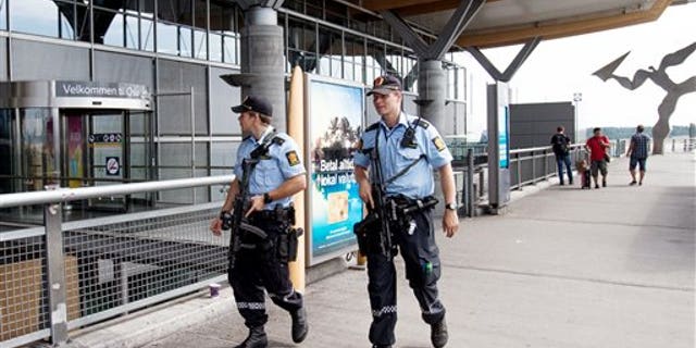 July 24: Armed Police patrol outside the terminal building at Oslo Airport. Norway's intelligence service says it has been warned of an imminent "concrete threat" against the nation from people with links to Islamic fighters in Syria.