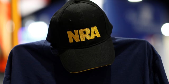 FILE -- A cap and shirt are displayed at the booth for the National Rifle Association (NRA) at the Conservative Political Action Conference (CPAC) at National Harbor, Maryland, U.S., February 23, 2018.