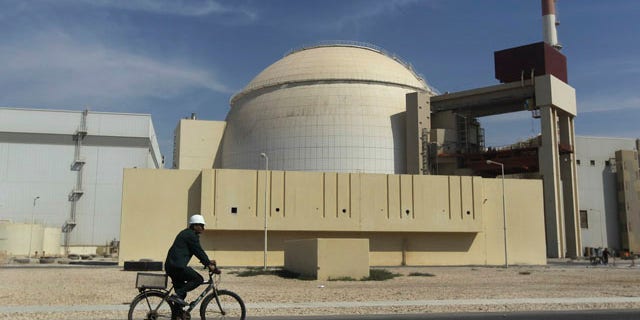Oct. 26, 2010: A worker rides a bike in front of the reactor building of the Bushehr nuclear power plant, just outside the southern city of Bushehr, Iran.
