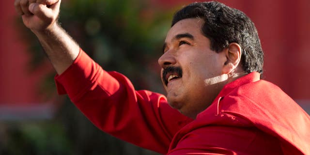 President Maduro gestures to supporters on Dec. 1, 2015, in the popular neighborhood of Petare, in Caracas.