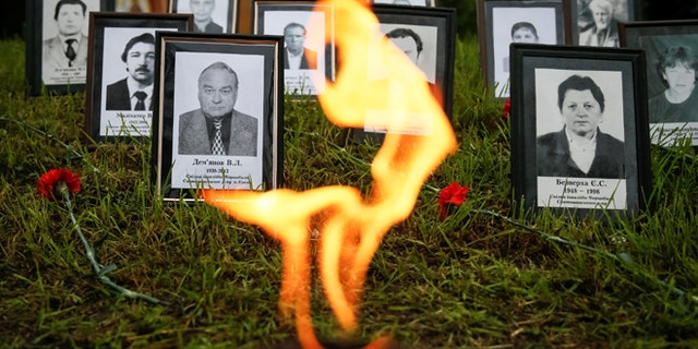 Portraits of "liquidators", emergency workers who fought the blaze at the Chernobyl nuclear reactor, are seen during a commemoration ceremony in Kiev, Ukraine, April 26, 2016. REUTERS/Gleb Garanich - RTX2BPDA