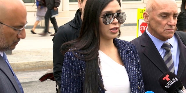 In this image taken from video, Emma Coronel, center, wife of notorious Mexican drug lord Joaquin "El Chapo" Guzman, is flanked by his defense lawyers, Eduardo Balarezo, left, and William Purpura, as she speaks with reporters.