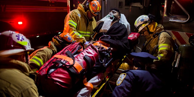 Dec. 22, 2016: Firefighters load an injured person into an ambulance during a fire on the west side of Manhattan in New York