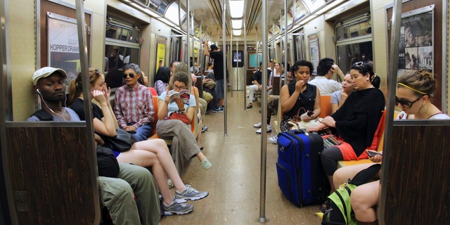 New York, USA - July 4, 2013: People ride Subway train in New York. With 1.67 billion annual rides, New York City Subway is the 7th busiest metro system in the world.