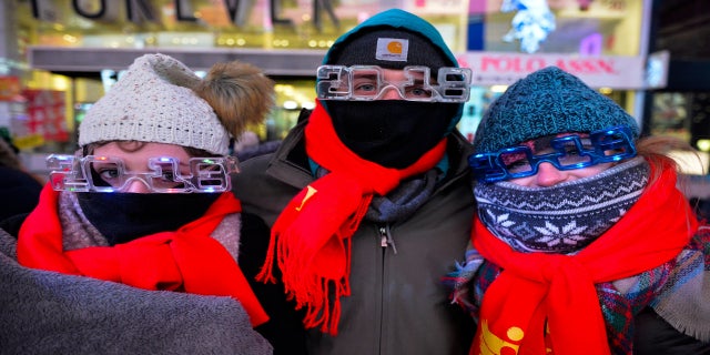 New Year's Eve revelers at Times Square in New York City dressed appropriately. From left are Elena Bardunniotis, Dominic Manshadi and Sarah Thompson, of Long Beach, Calif.