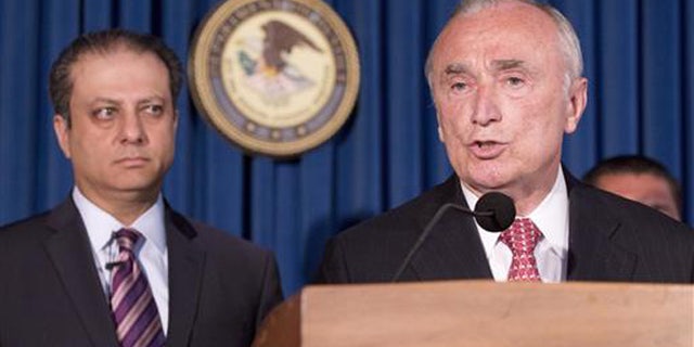U. S. Attorney Preet Bharara, left, listens as New York City Police Commissioner William Bratton discusses the arrest of four people in connection with New York City's ongoing corruption probe, Monday, June 20, 2016, in New York.