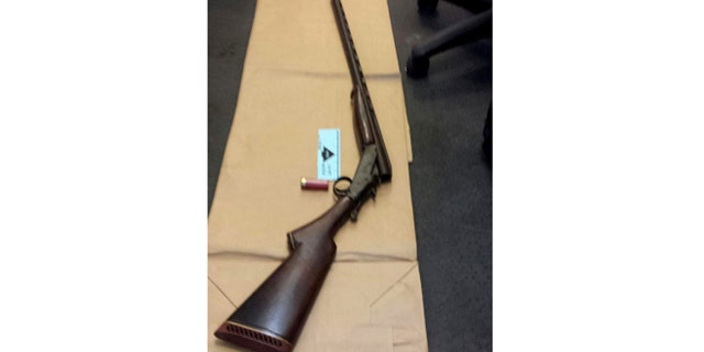 Apr. 12, 2014: This photo provided by the New York City Police Department shows a shotgun displayed on the floor of a police precinct in New York.