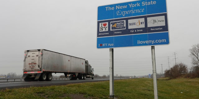 Nov. 29, 2016: A truck passes a sign for "I Love New York" and other state attractions on the New York State Thruway in Utica, N.Y.