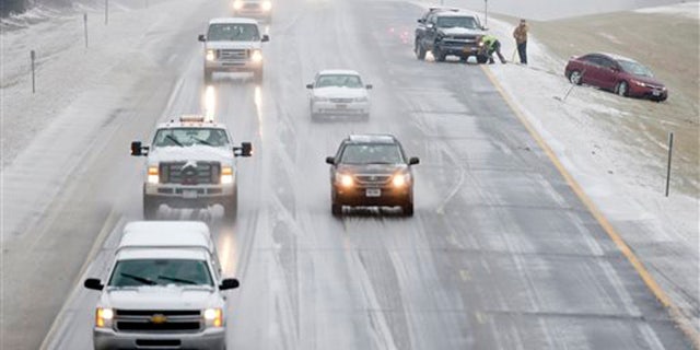 A vehicle is pulled from the median on Interstate 90 on Tuesday, Dec. 29, 2015, in East Greenbush, N.Y. Snow, sleet, freezing rain and gusty winds are creating treacherous driving conditions across upstate New York as eastern parts of the state receive their first severe weather of the winter season. (AP Photo/Mike Groll)