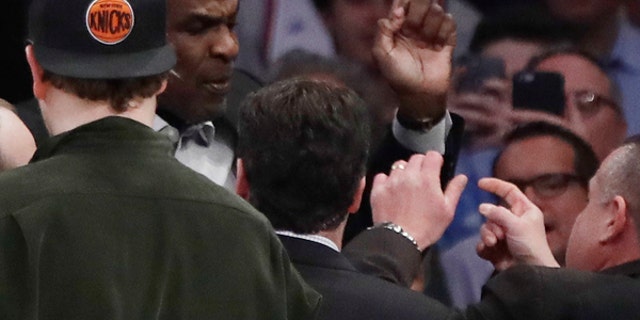 Charles Oakley is confronted by security personnel at Madison Square Garden during a Knicks game.