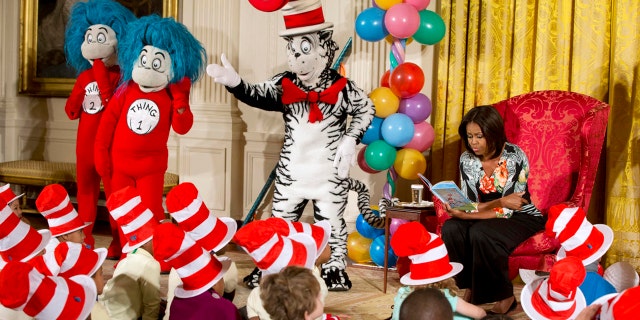 First lady Michelle Obama, with Dr. Seuss characters the Cat in the Hat, Thing 1 and Thing 2, reads to local students as part of her "Let's Move, Let's Read!" initiative, Wednesday, Jan. 21, 2015. (AP Photo/Jacquelyn Martin)