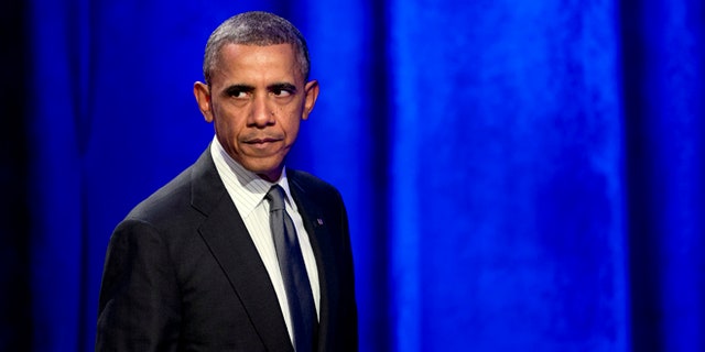Feb. 25, 2014: President Obama glances at the crowd as walks off the stage after speaking at the National Organizing Summit in Washington.