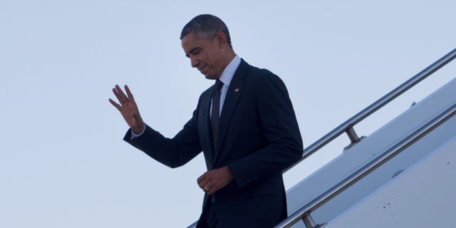 Nov. 15, 2014:  U.S. President Barack Obama waves as he arrives at Royal Australian Air Force Base Amberley near Brisbane, Australia