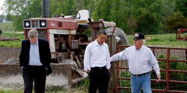 In this April 28, 2010, file photo President Barack Obama, and Agriculture Secretary Tom Vilsack, left, tour a farm in Palmyra, Mo., with owner Lowell Schachtsiek, right.