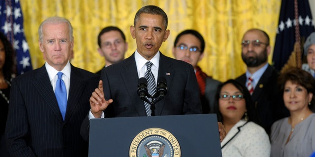 President Obama, standing next to Vice President Biden, urges Congress to take back up comprehensive immigration reform while speaking in the East Room of the White House in Washington, Thursday, Oct. 24, 2013.