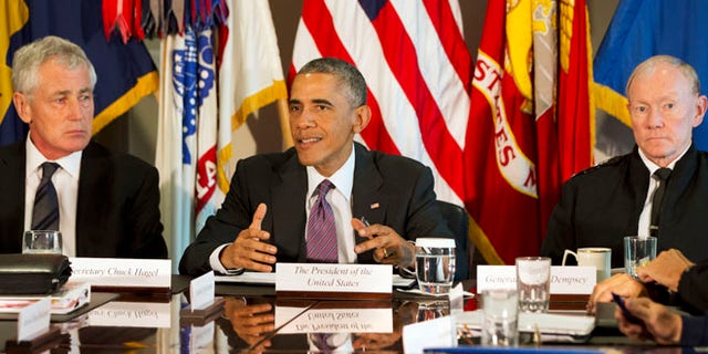 Oct. 8, 2014: President Barack Obama, flanked by Defense Secretary Chuck Hagel, left, and Joint Chiefs Chairman Gen. Martin Dempsey, speaks to the media at the conclusion of a meeting with senior military leadership