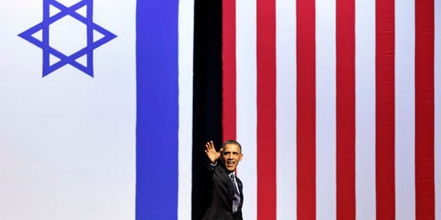 March 21, 2013: President Barack Obama waves as he leaves the stage after speaking at the International Convention Center in Jerusalem.