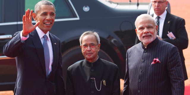 Jan. 25, 2015: U.S. President Barack Obama waves, as Indian President Pranab Mukherjee, center, and Prime Minister Narendra Modi stand beside him during a ceremonial reception at the Indian presidential Palace in New Delhi, India.