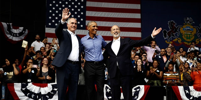 Former President Barack Obama stands with Sen. Bob Casey D-Pa., left, and Gov. Tom Wolf, during a campaign rally in Philadelphia on Friday.