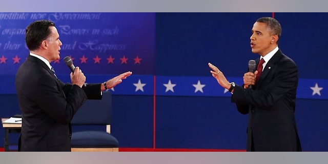 FiOCTOBER 16: Republican presidential candidate Mitt Romney (L) and U.S. President Barack Obama talk to each other during a town hall style debate at Hofstra University October 16, 2012 in Hempstead, New York. During the second of three presidential debates, the candidates fielded questions from audience members on a wide variety of issues. (Photo by Bruce Bennett/Getty Images)