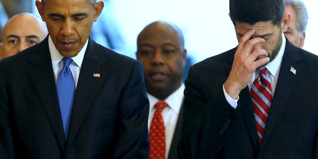 U.S. House Speaker Paul Ryan and President Barack Obama stand together at the end of a ceremony commemorating the 150th anniversary of the 13th Amendment, which formally abolished slavery in the aftermath of the U.S. Civil War, at the U.S. Capitol in Washington, December 9, 2015.