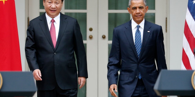 President Barack Obama and Chinese President Xi Jinping arrive for their joint new conference, Friday, Sept. 25,2015, in the Rose Garden of the White House in Washington. (AP Photo/Evan Vucci)