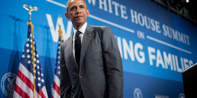 June 23, 2014: President Obama walks off stage after speaking at the White House Summit on Working Families in Washington.