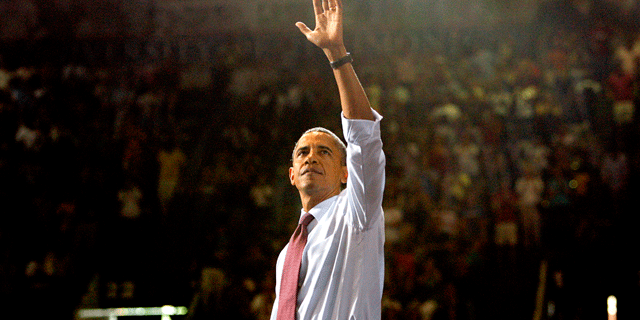 President Obama waves to the crowd filling the Robins Center after speaking about his jobs plan at the Univeristy of Richmond on Friday, September 9, 2011.