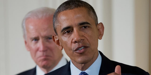 Jan. 22, 2014: Vice President Joe Biden listens as President Barack Obama speaks in the East Room of the White House in Washington.