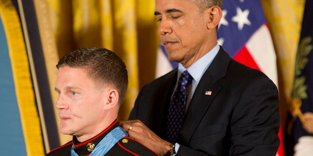 President Obama bestowing the Medal of Honor on retired Marine Cpl. William 'Kyle' Carpenter at the White House in 2014.