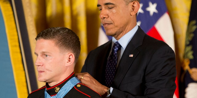 President Obama bestowing the Medal of Honor on retired Marine Cpl. William 'Kyle' Carpenter at the White House in 2014.