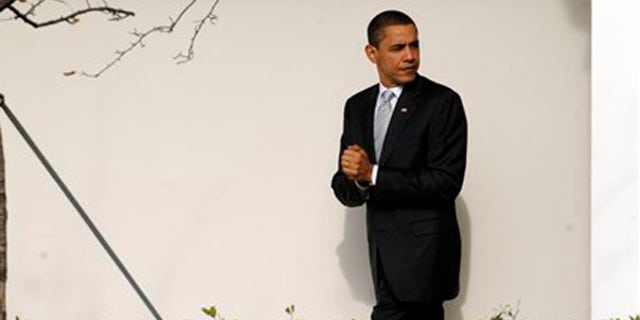 President Barack Obama walks along the Colonnade at the White House in Washington, Tuesday, Dec. 15, 2009. (AP)
