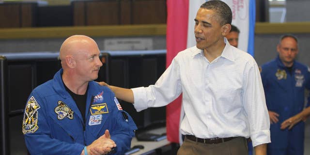 President Barack Obama meets with Space Shuttle Endeavor commander Mark Kelly, husband of wounded Rep. Gabrielle Giffords, D-Ariz., and shuttle astronauts, after their launch was scrubbed, Friday, April 29, 2011, at Kennedy Space Center in Cape Canaveral, Fla. (AP Photo/Charles Dharapak)